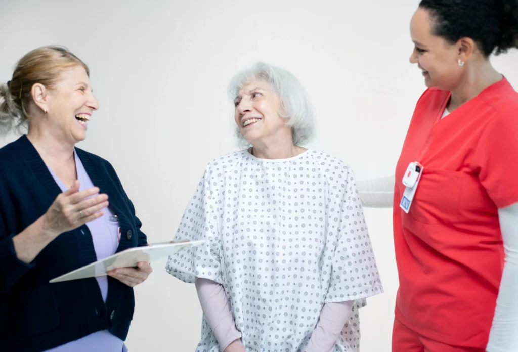 doctor and healthcare workers talking and laughing with patient