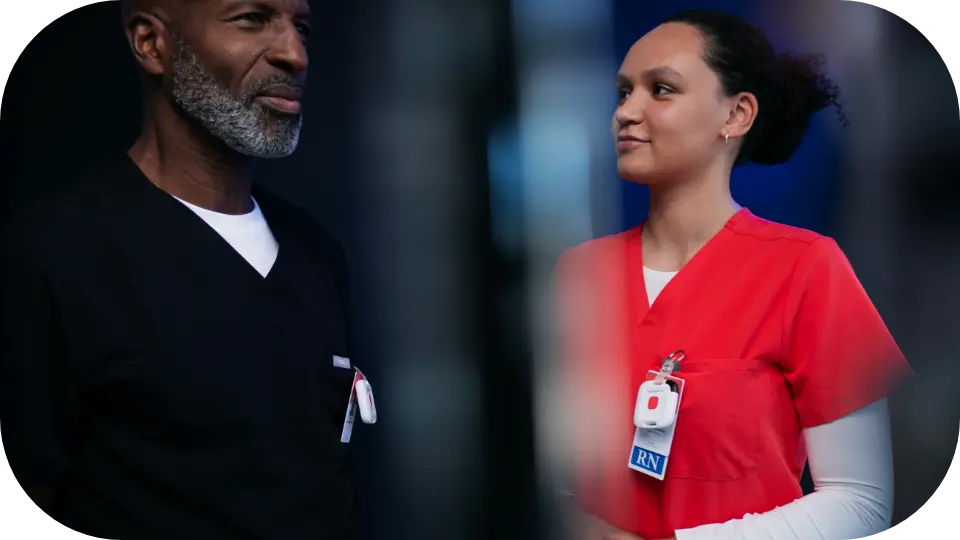 Hospital physician and nurse reviewing operational data on a tablet — illustrating real-time clinical decision-making.
