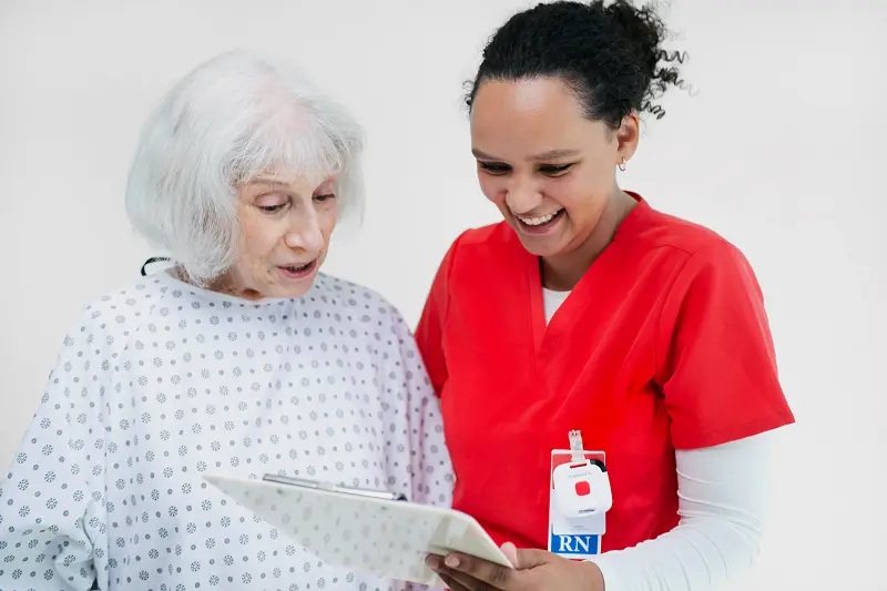 patient rounding nurse with patient